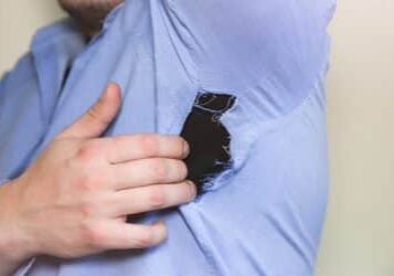 Ripped shirt. Man in clothes which need repairing and sewing.