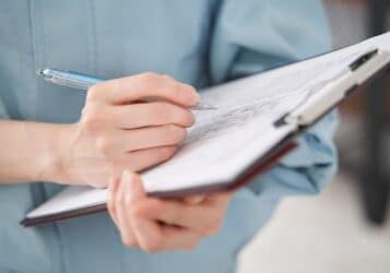 A Japanese female worker at hand inspecting a house's equipment