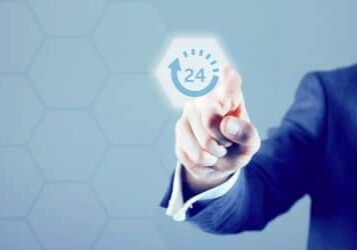 Male hand points to a modern digital screen. A 24 hour symbol is being pressed and is illuminated.