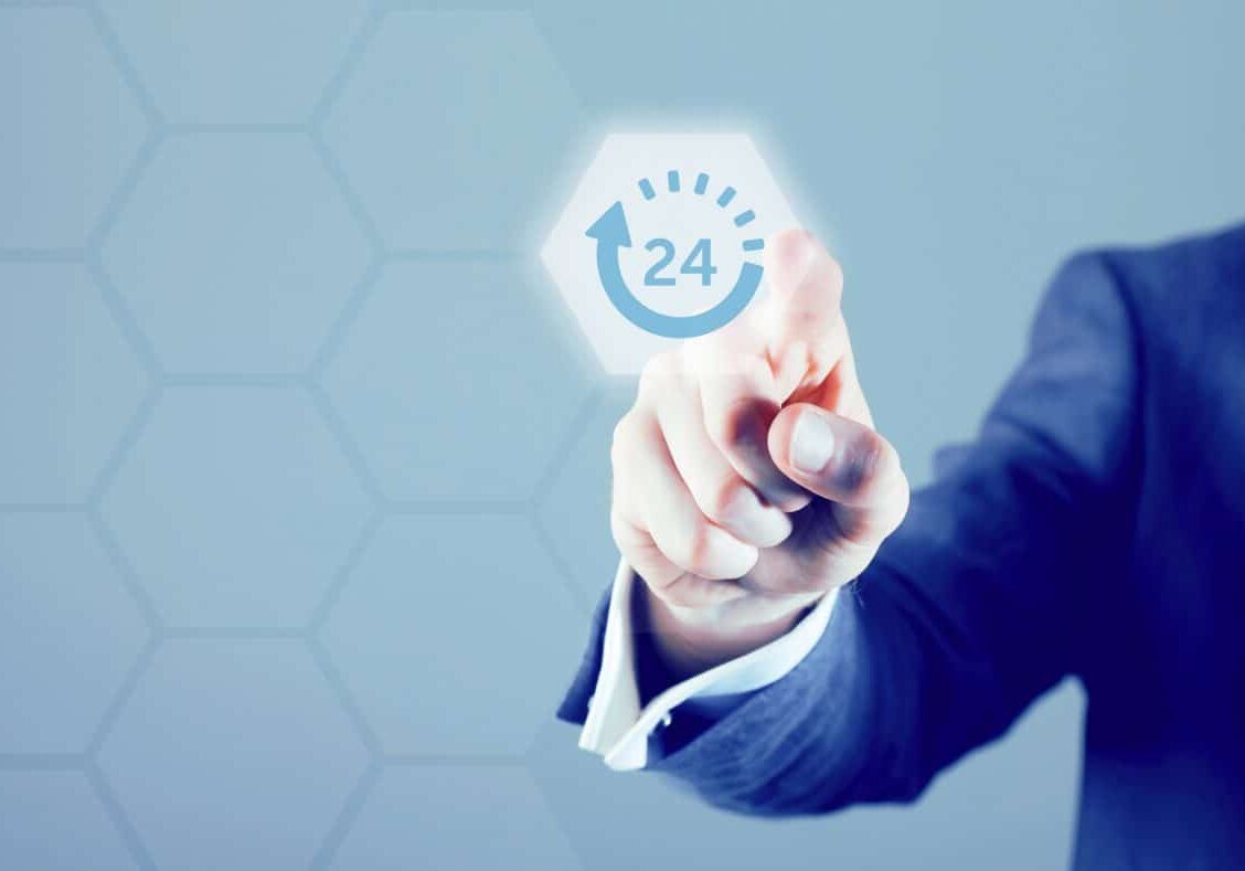 Male hand points to a modern digital screen. A 24 hour symbol is being pressed and is illuminated.