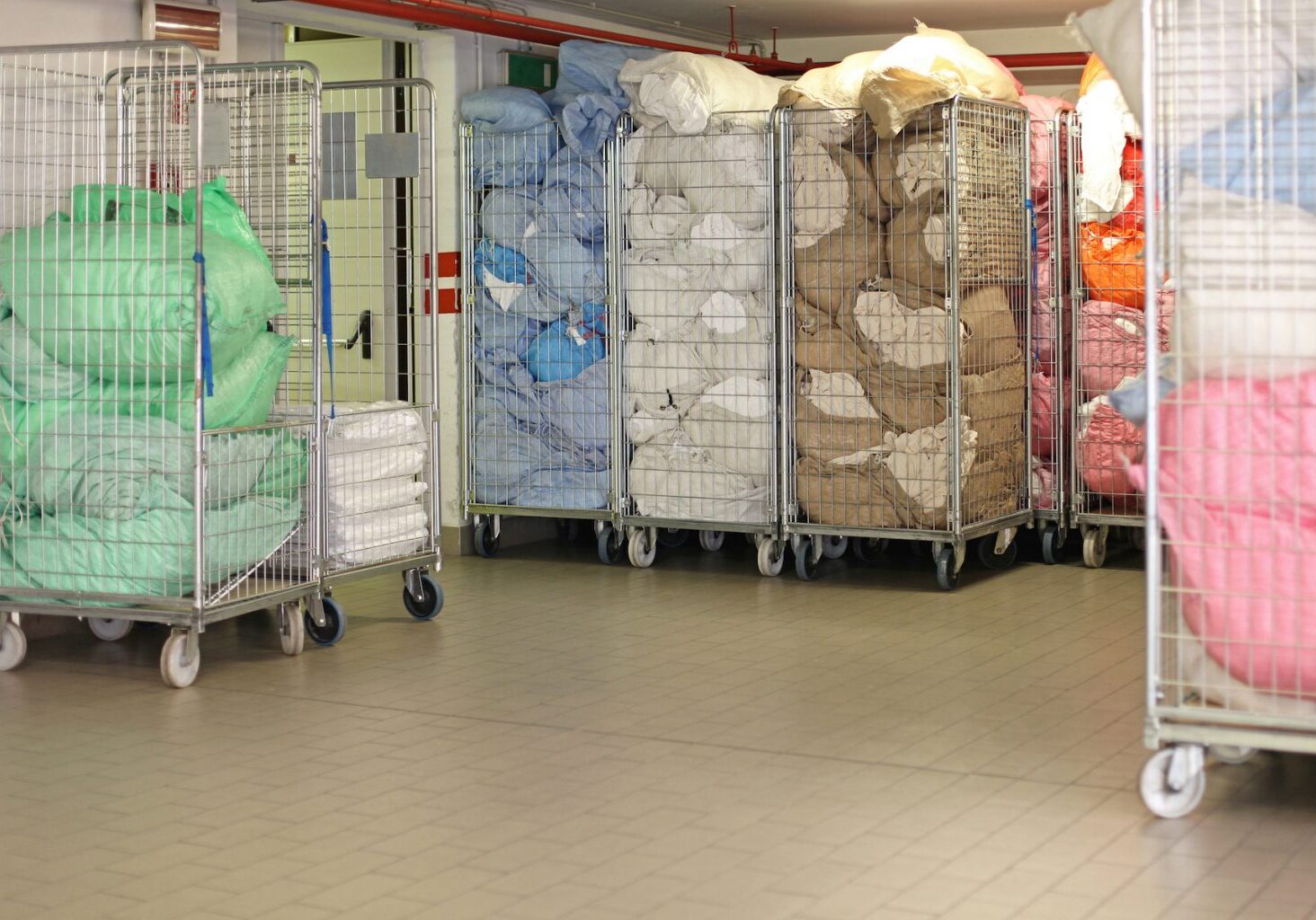 Bags With Dirty Laundry Sheets in Rolling Carts