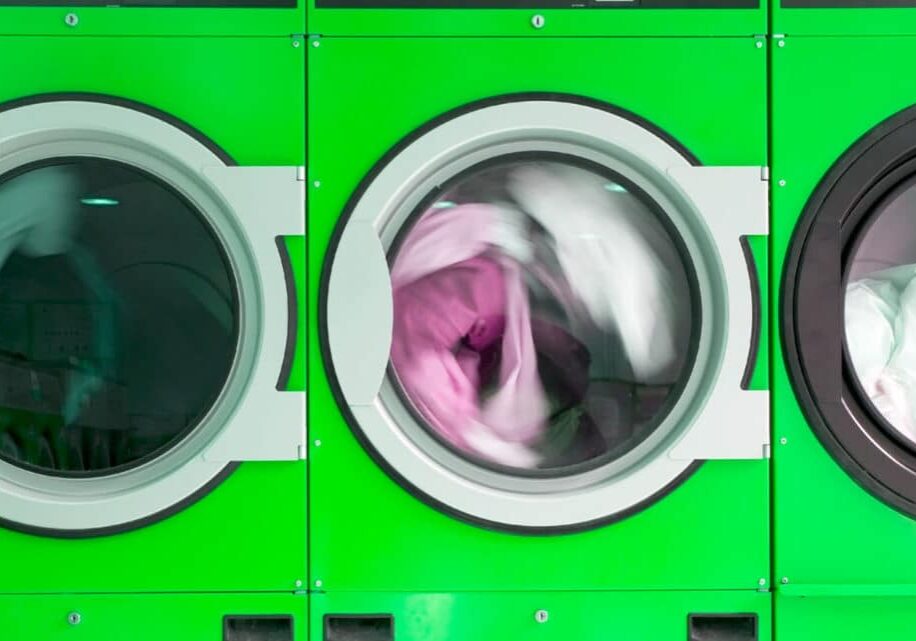 green clothes washers in a laundrette
